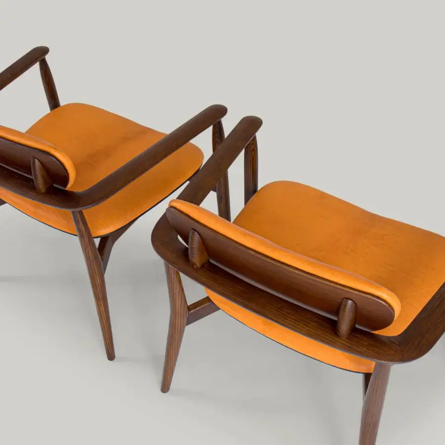 Distinguished Borzalino Regina lounge chair with warm orange-brown leather upholstery and dark finished solid wood structure
