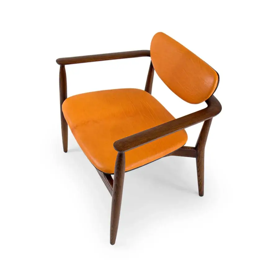 Exceptional Borzalino Regina lounge chair with fixed cushions upholstered in vibrant orange material and solid wood structure