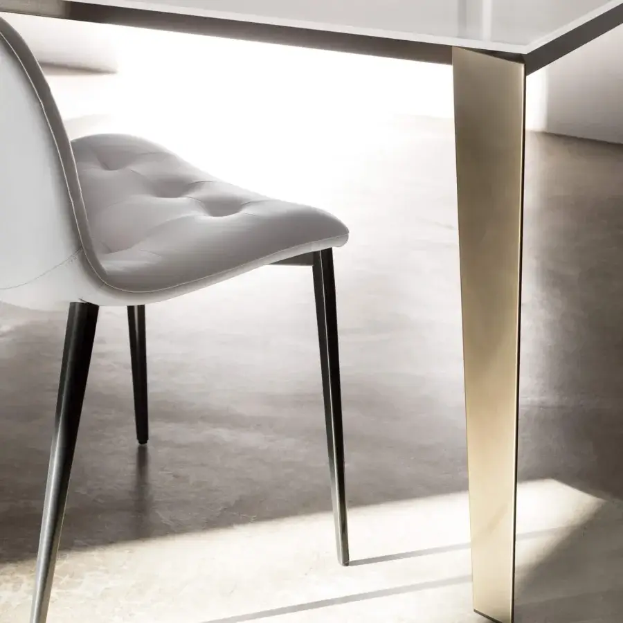 Elegant Bontempi Kuga chair upholstered in white synthetic material with button-tufted detailing and slender dark metal legs