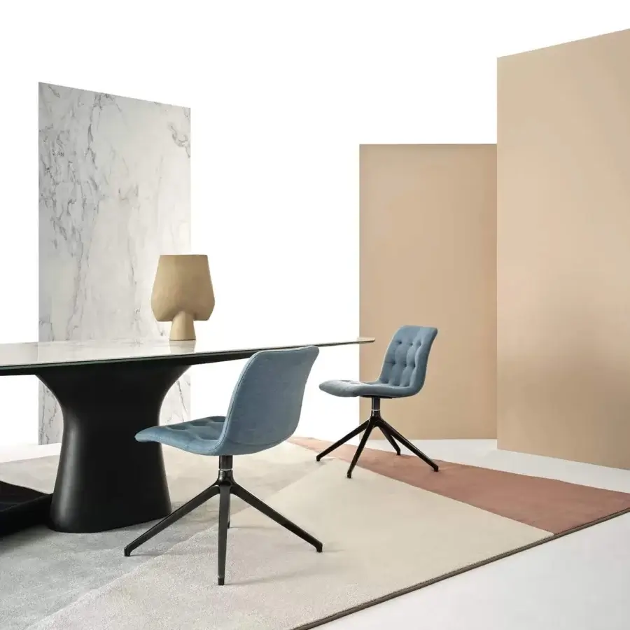 Distinguished Bontempi Kuga chair with light blue textile upholstery and dark metal base, crafted in a sleek silhouette with button-tufted back