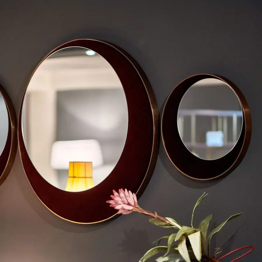 Distinguished Borzalino Eclipse mirror crafted in treated brass with reddish-brown wood-like material and gold metallic accents