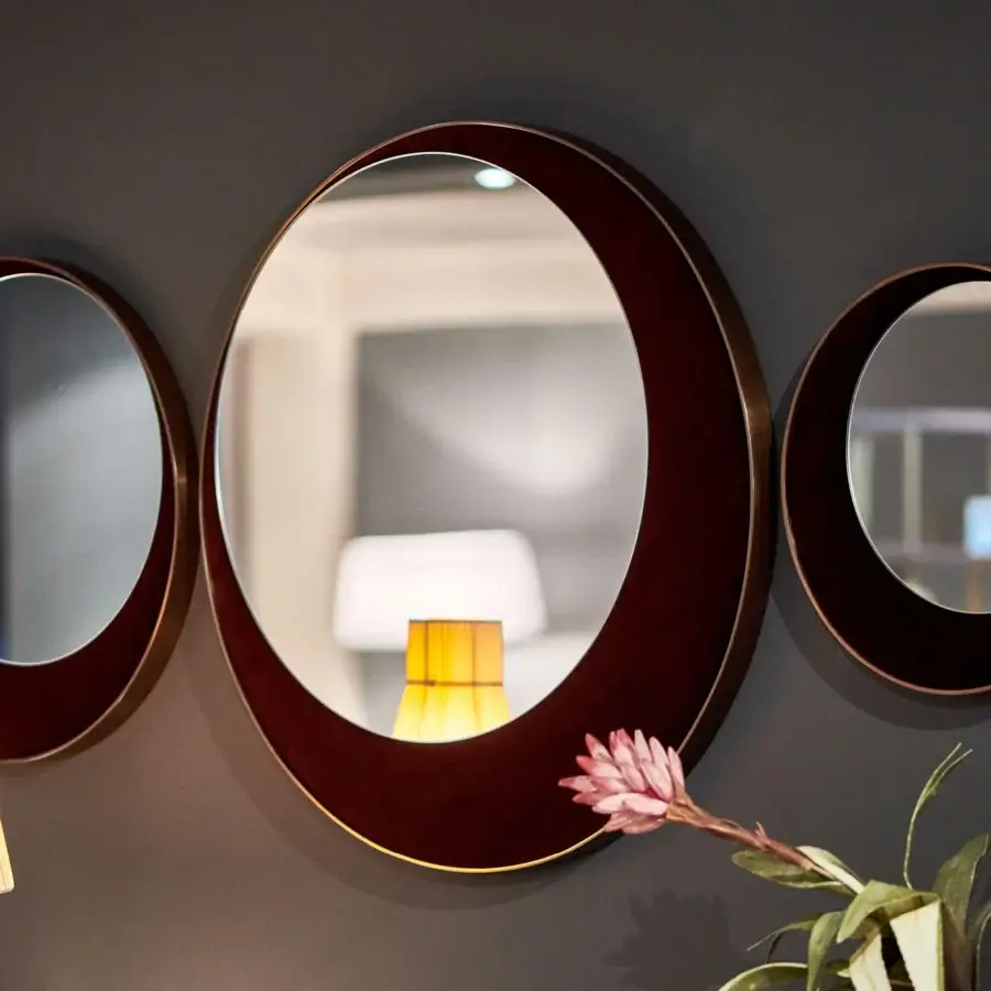 Exceptional Borzalino Eclipse mirror with circular form crafted in treated brass and reddish-brown wood with gold accent