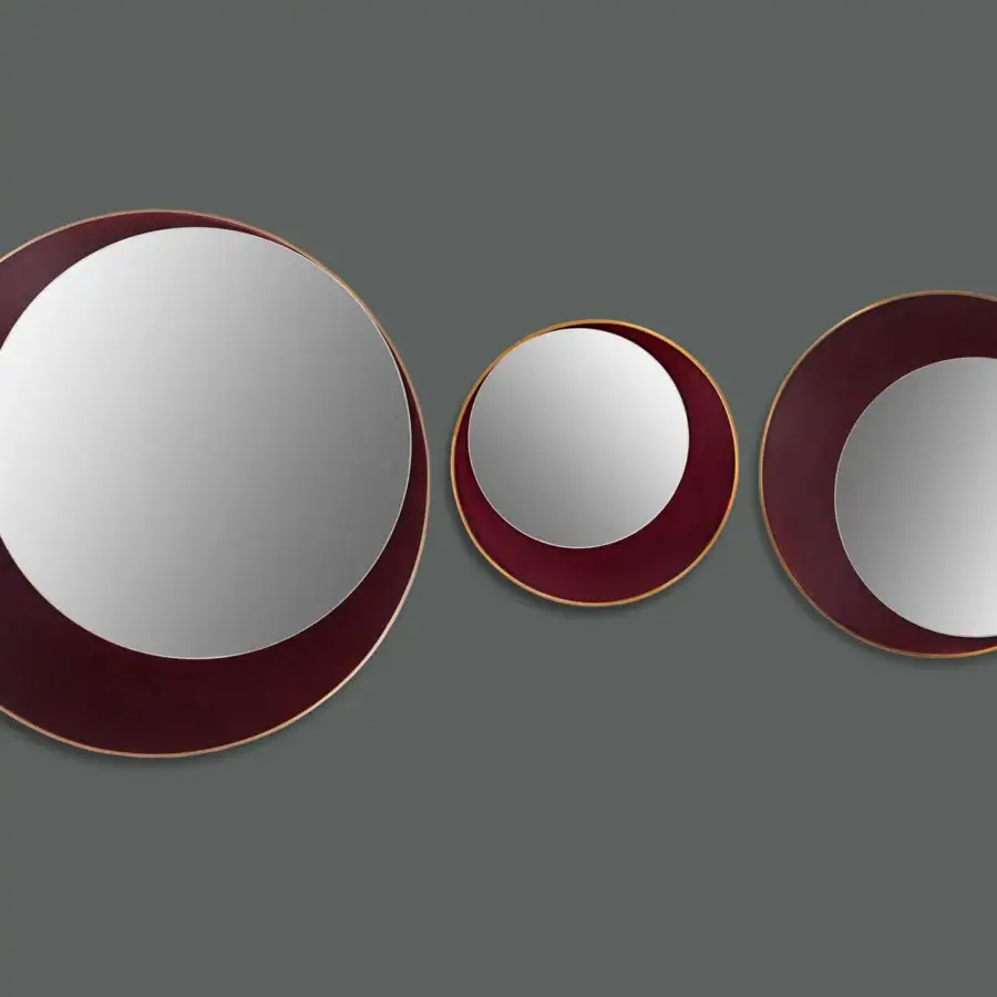 Distinguished Borzalino Eclipse mirror with a circular design and treated brass metal frame in burgundy leather or fabric with gold trim