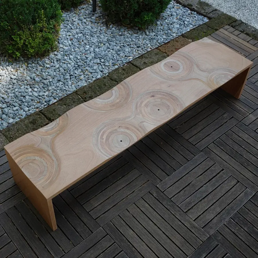 Superior Horm Ripples bench crafted from okoume wood with a smooth, light brown finish exhibiting a contemporary swirling silhouette
