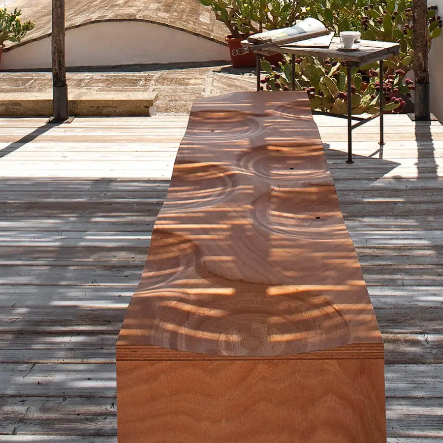 Innovative Horm Ripples bench crafted in Italy with warm light brown okoume wood and smooth glossy finish