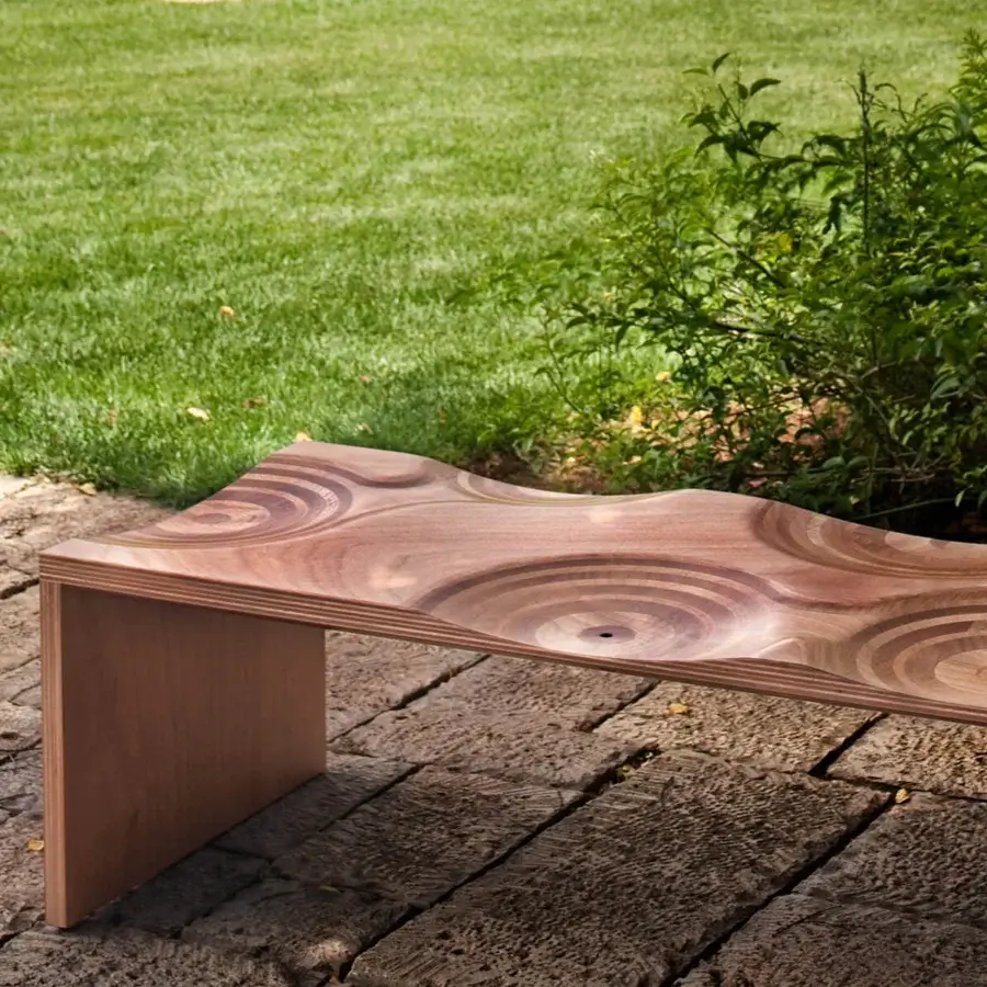 Distinguished Horm Ripples bench crafted in Italy with warm brown okoume wood and smooth finish displaying unique circular indentations