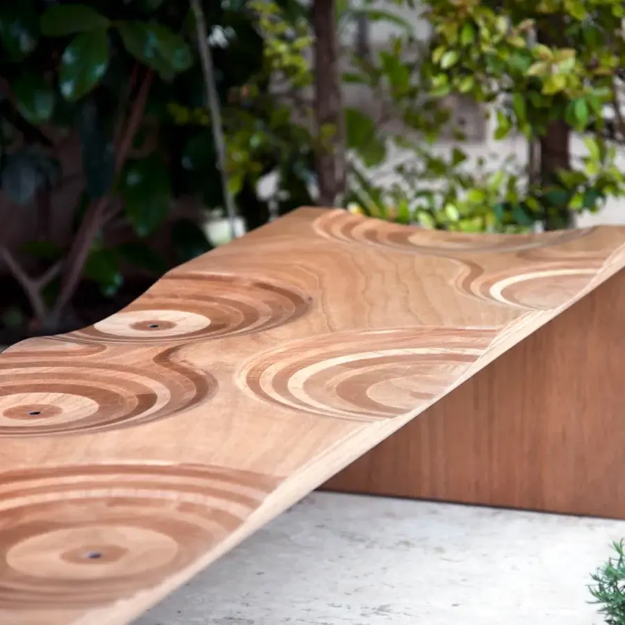 Exceptional Horm Ripples bench crafted in Italy with light okoume wood exhibiting carved concentric rings and a matte coating