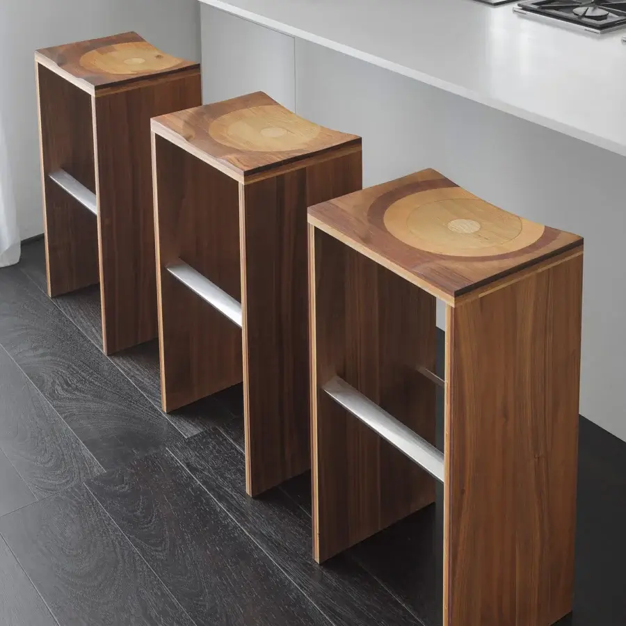 Distinguished Horm Ripples stool with saddle seat crafted in laminated composite walnut, mahogany, cherry, oak and ash with hand-finished details