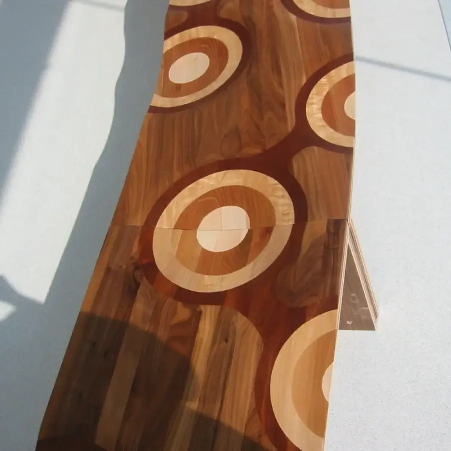 Distinguished Horm Ripples "Like a River" bench built with walnut, mahogany, cherry, oak, and ash, showcasing a glossy sheen