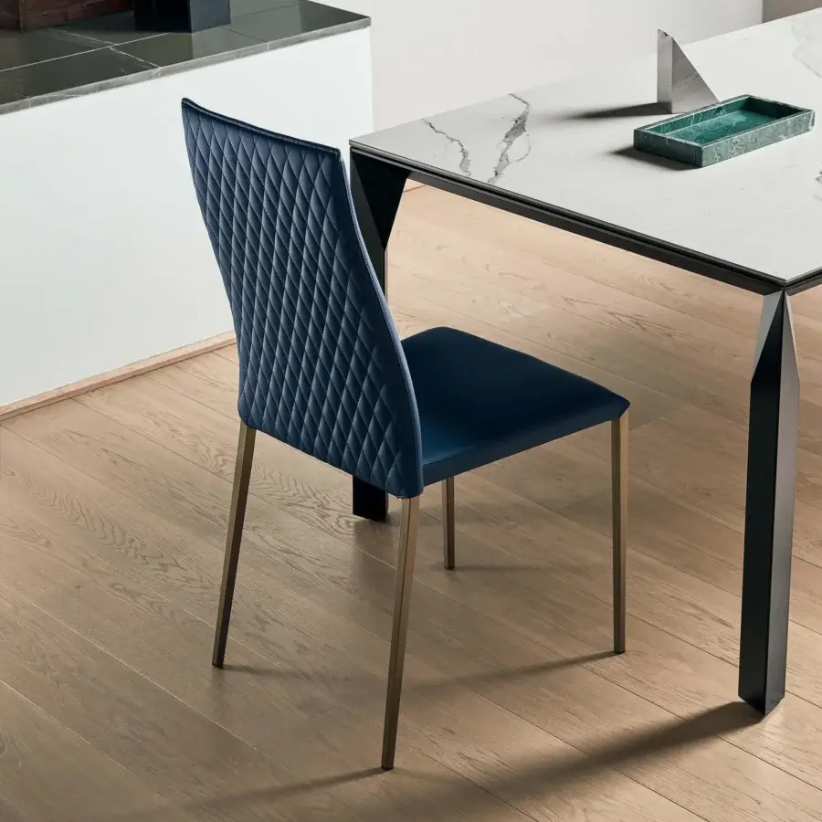 Elegant Bontempi Tai chair with curved lines and quilted upholstery in dark blue textile with bronze tone metal legs