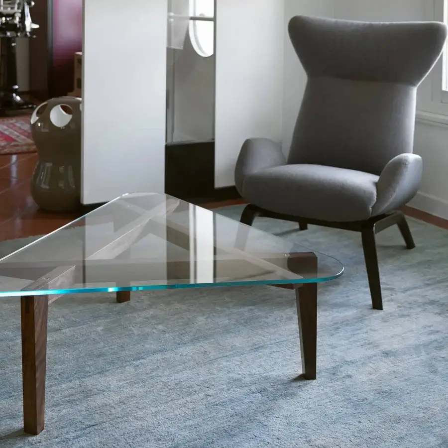 Elegant Horm Soho lounge chair with enveloping gray textile and dark-toned wooden leg base crafted in Italy