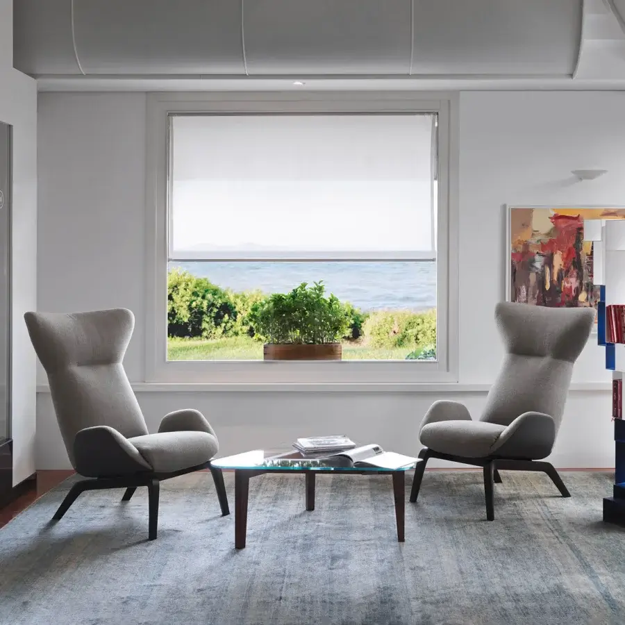 Exceptional Horm Soho lounge chair with enveloping light gray premium fabric and dark-finished wooden legs