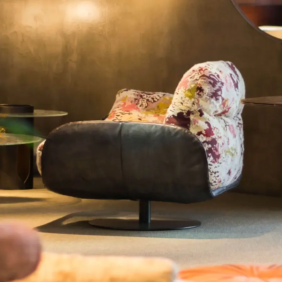 Refined Borzalino Ayton lounge chair with floral fabric cushions and dark leather, built with a curved metal tube frame and lacquered base
