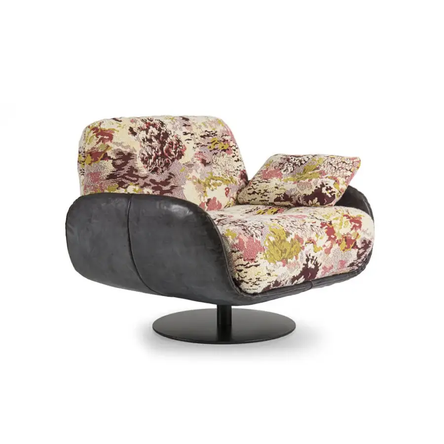 Distinguished Borzalino Ayton lounge chair built with floral fabric upholstery and dark matte leather, elevated with lacquered metal feet