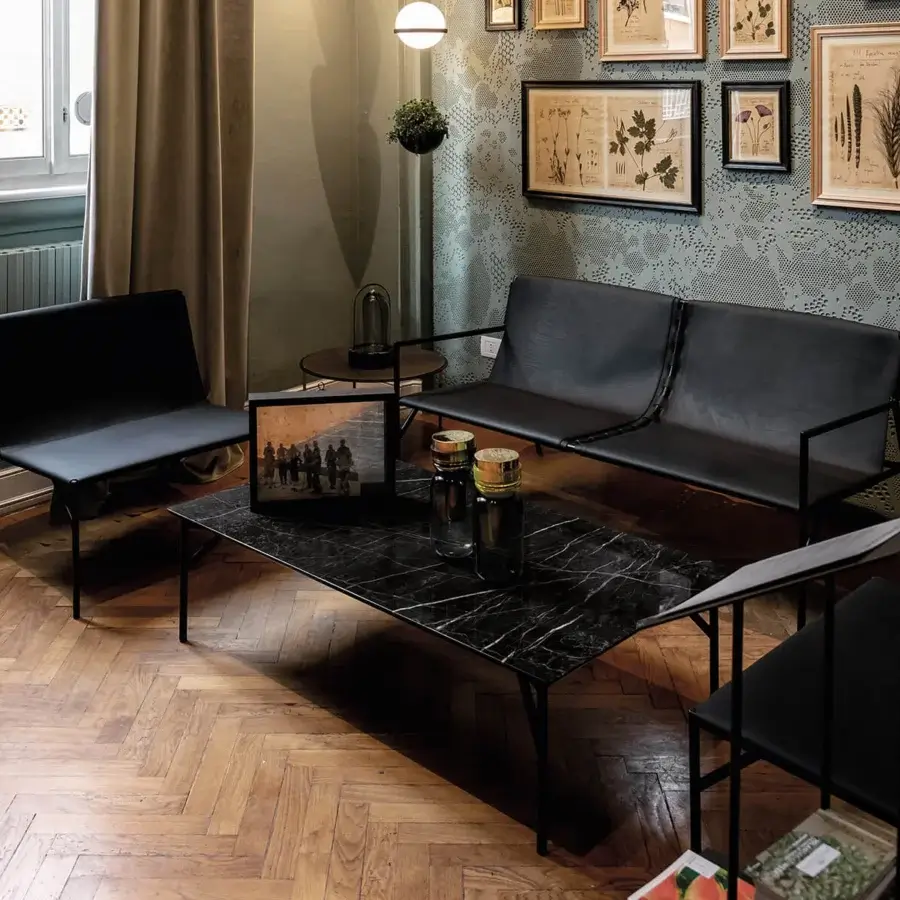 Superior Horm Tout Le Jour lounge chair with dark metal frame and smooth black leather seat built in Italy