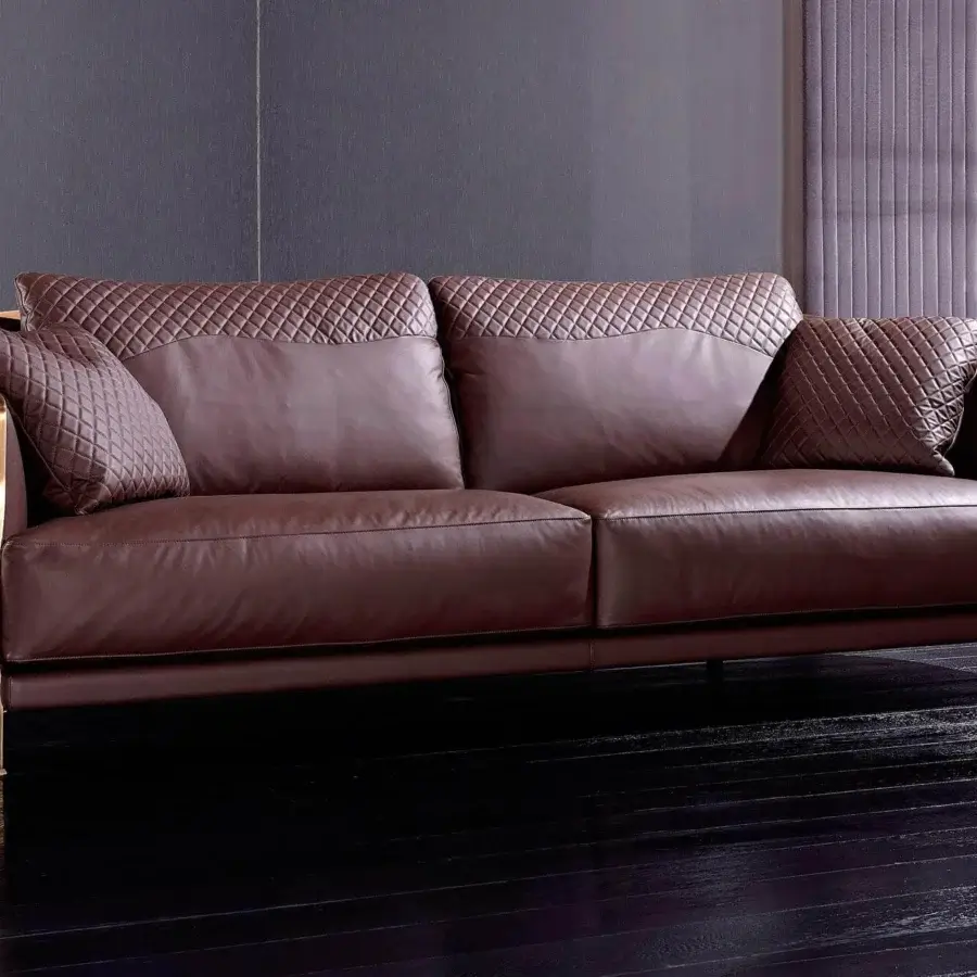 Distinguished Rugiano Paris sofa upholstered in deep brown leather with quilted diamond detailing and lustrous brass-colored twisted metal structure