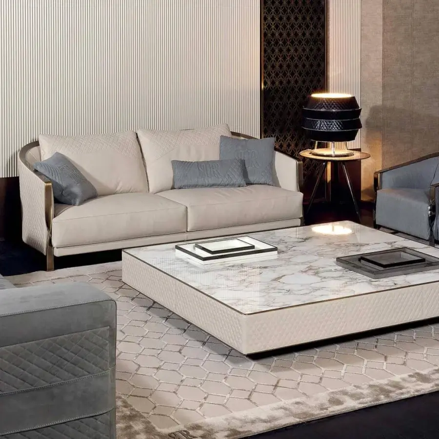 Exceptional Rugiano Paris sofa upholstered in light beige textile with quilted detailing and twisted gold finish
