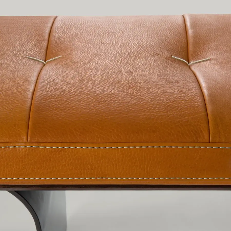 Superior Borzalino Minerva bench with tan leather seat and lacquered veneered wood base built with curved metal feet