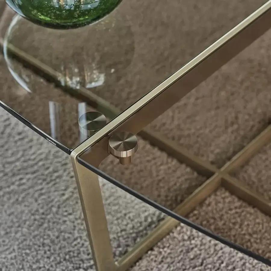 Distinguished Bontempi Cross coffee table with organic glass top and muted gold metal frame