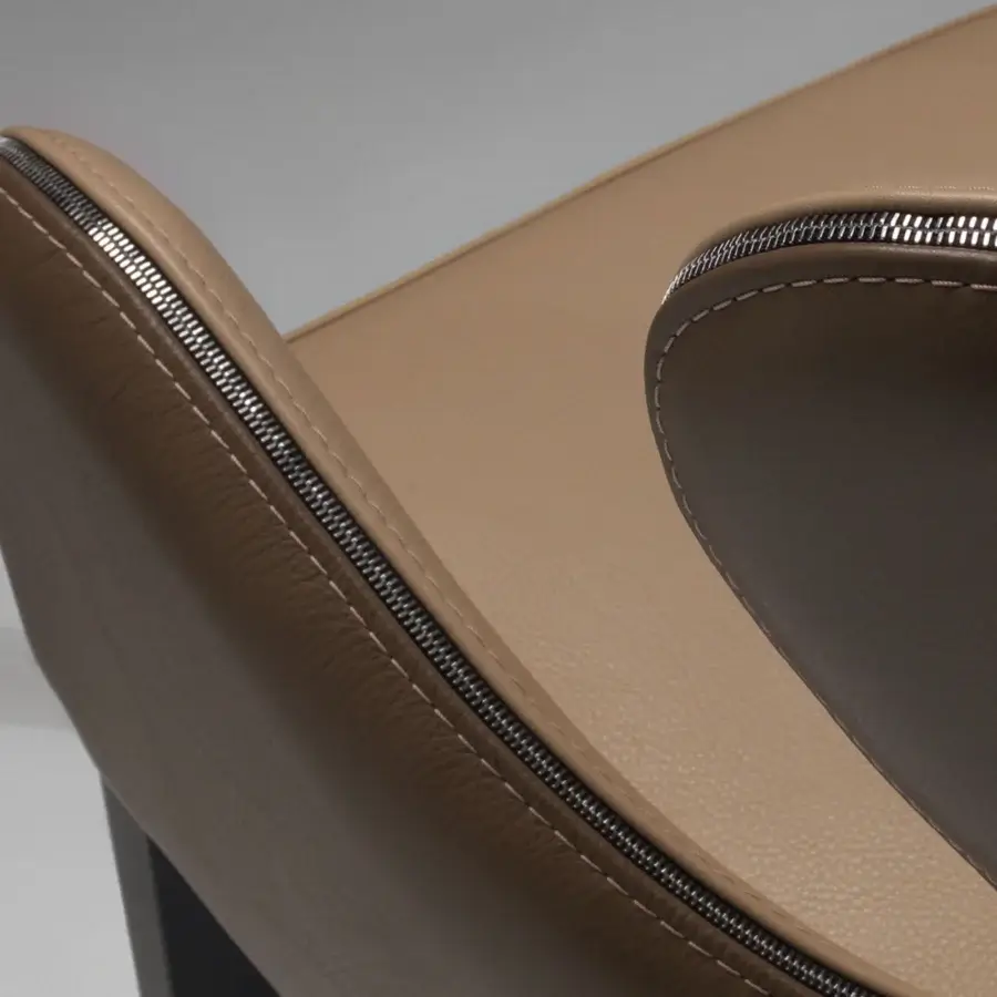 Lavish Borzalino Elektra armchair upholstered in light tan leather with dark brown armrests and a chromed metal zipper