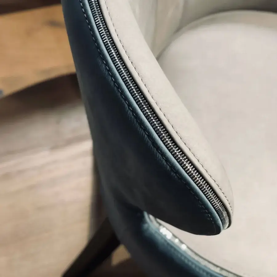 Distinguished Borzalino Elektra armchair with sinuous curves upholstered in light gray fabric and a matte finish with chromed metal accents and natural oak legs