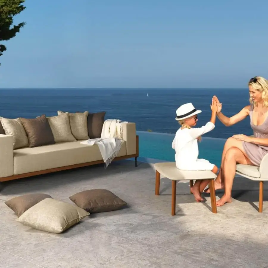Elegant Talenti Cleo sofa with a natural teak wood frame and light beige weather-resistant fabric cushions