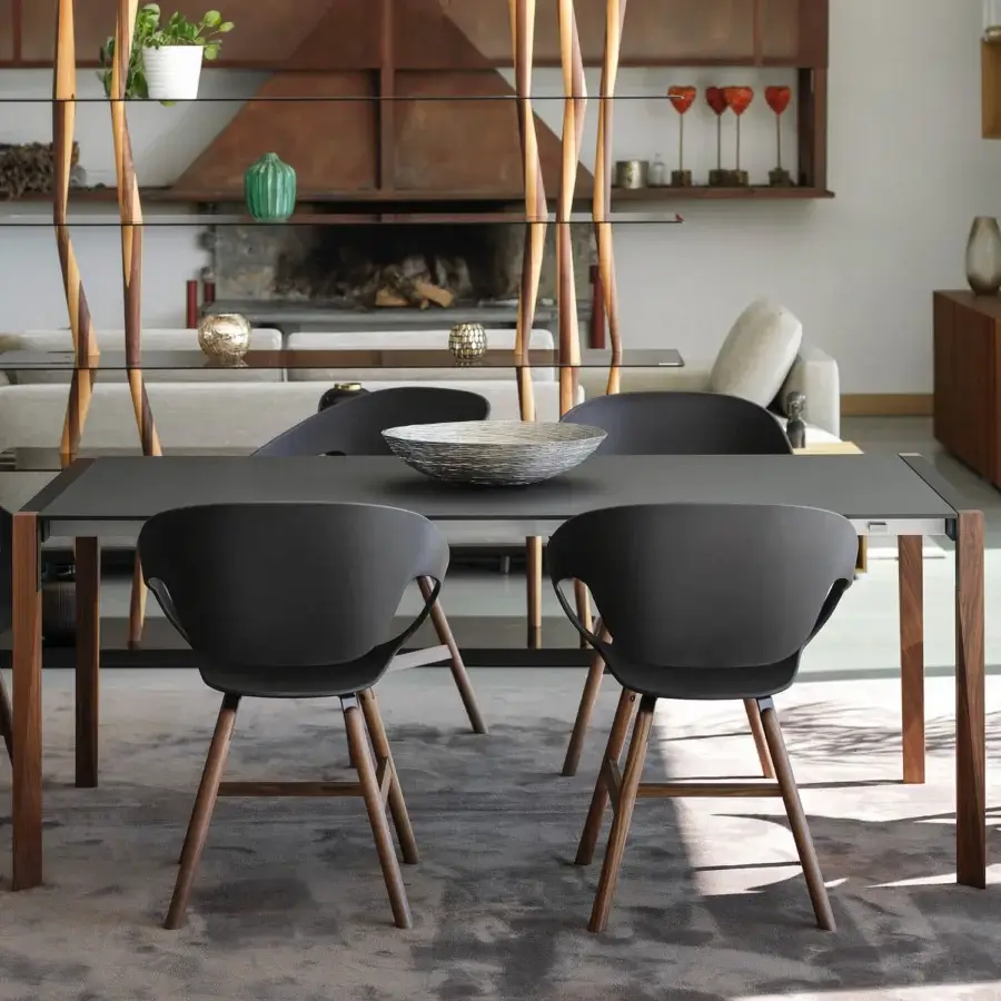 Superior Horm Tango table with a dark matte Fenix tabletop and subtly angled wooden legs built with a sleek metal framework