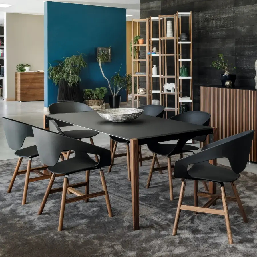 Exceptional Horm Tango table with a matte black Fenix top and elegantly angled wooden legs crafted in Italy