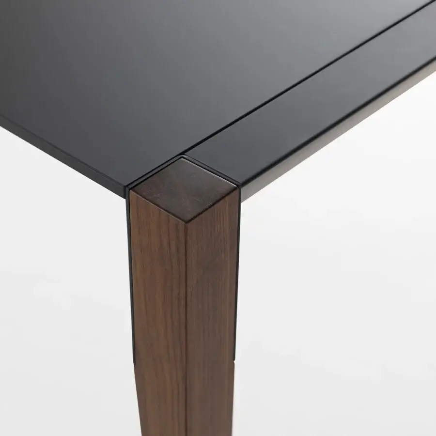 Superior Horm Tango table crafted in Italy with a dark matte Fenix tabletop and medium-toned brown wood leg