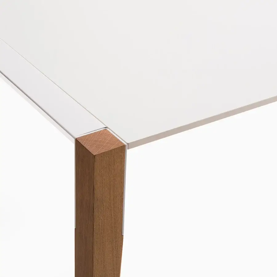 Elegant Horm Tango table crafted in Italy with a white matte Fenix tabletop and angled medium brown wooden legs