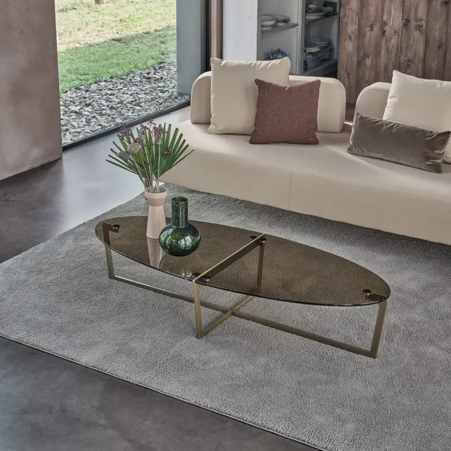 Distinguished Bontempi Cross coffee table with dark tinted glass top and golden-toned metal frame showcasing an oval layered design