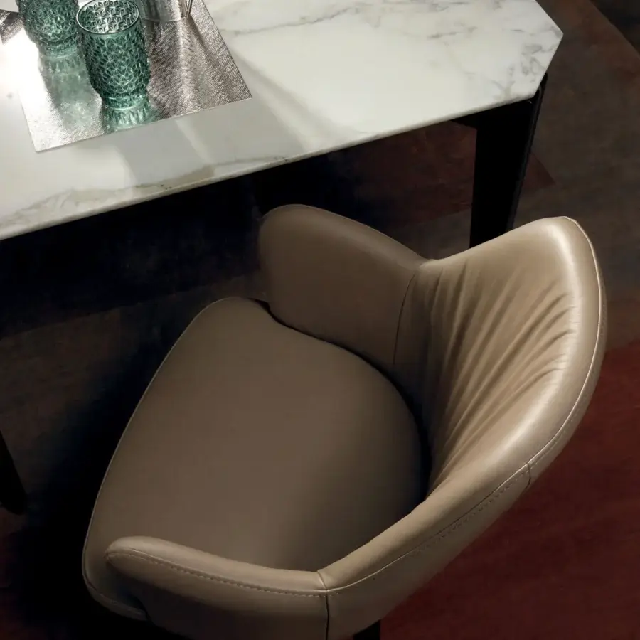 Distinguished Borzalino Bob armchair with enveloping curved silhouette upholstered in beige textile and built with solid natural oak legs