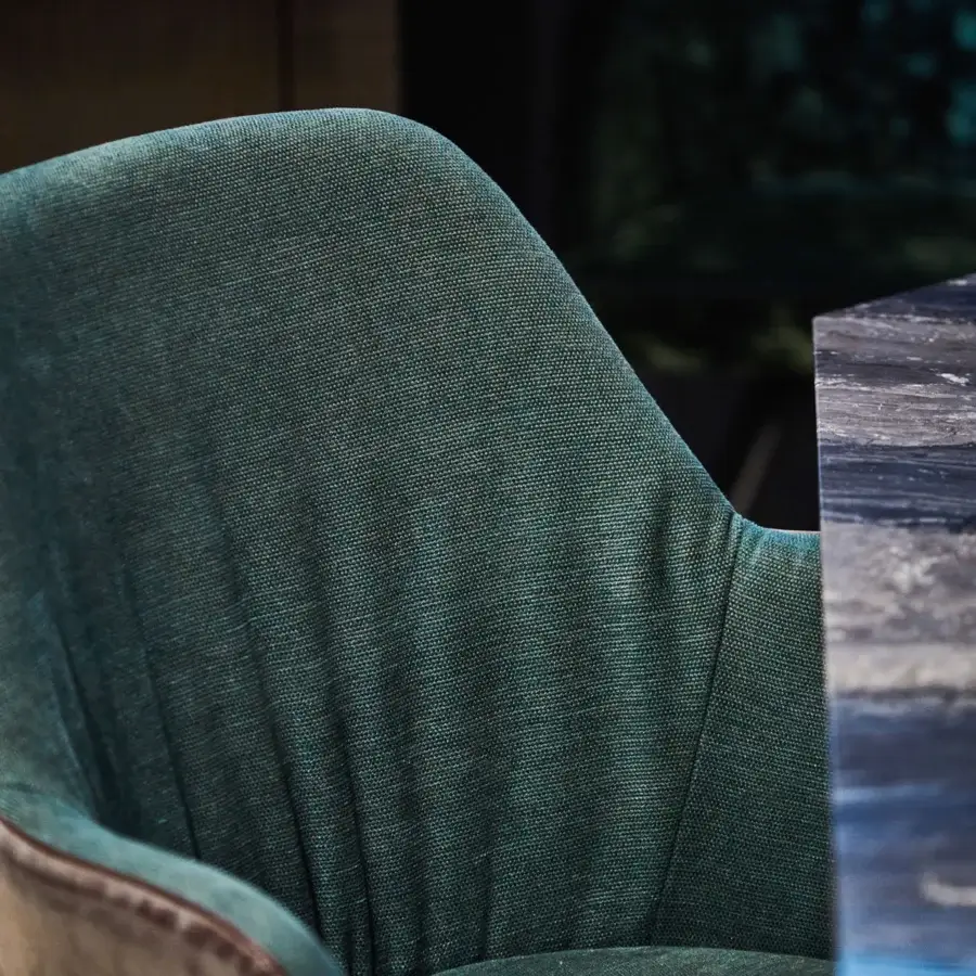 Distinguished Borzalino Bob armchair upholstered in textured teal textile with a solid natural oak “R” base and brown stitched edging