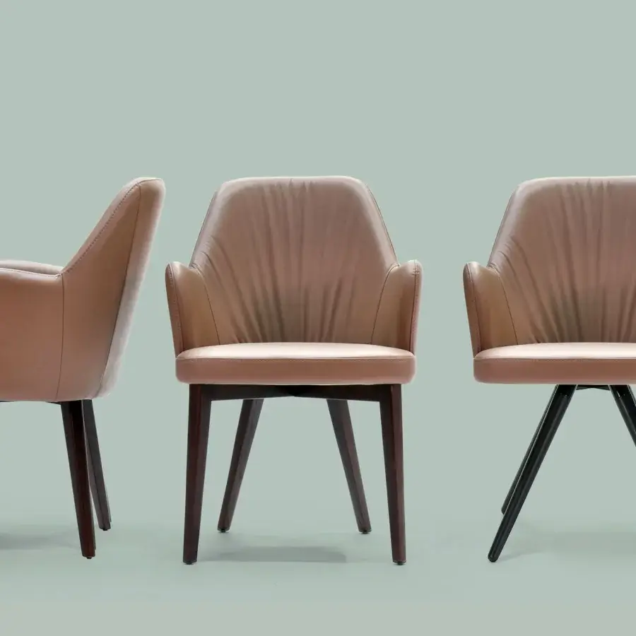 Exceptional Borzalino Bob armchair with enveloping curvature upholstered in light brown material and built with solid natural oak legs