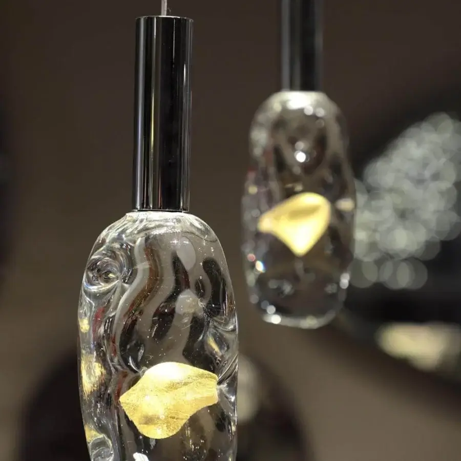 Elegant Reflex Sassi suspension lamp with transparent Murano glass and golden interior crafted in glossy silver metal
