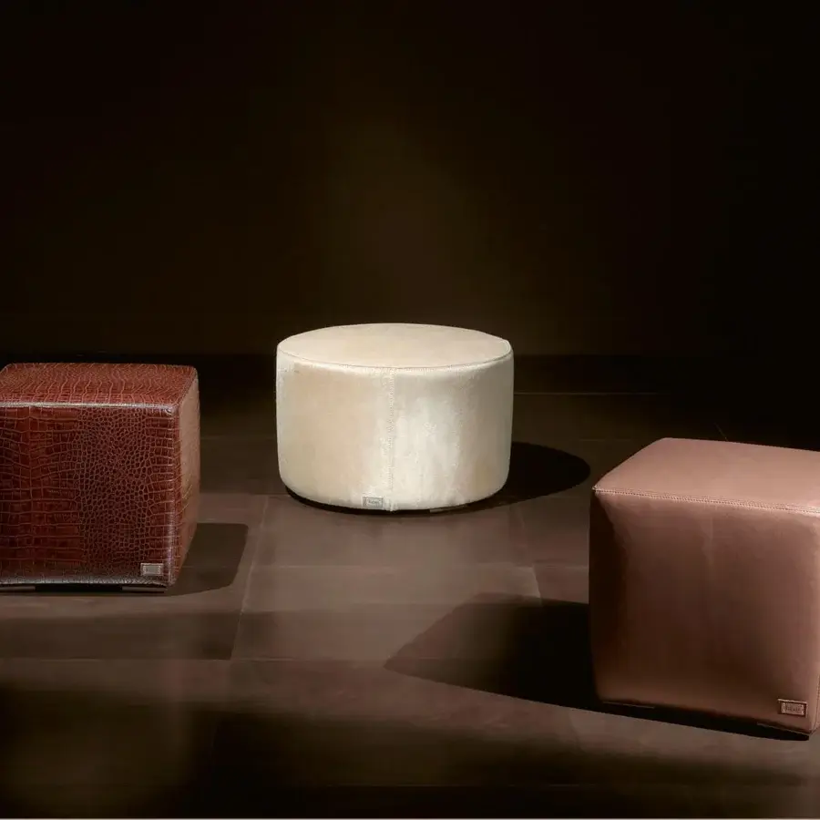 Distinctive Rugiano Form ottoman upholstered in smooth light brown leather with a sleek steel base