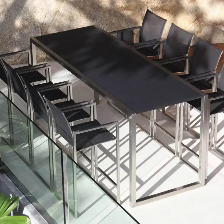 Elegant Royal Botania Ninix bar table with dark ceramic top and matte stainless steel frame presents angular forms
