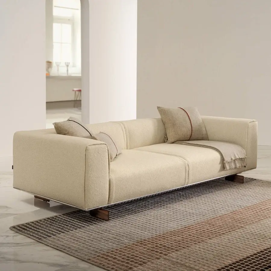 Distinguished Horm Coleman sofa with light beige textile and solid canaletto walnut feet, showcasing two red-lined cushions