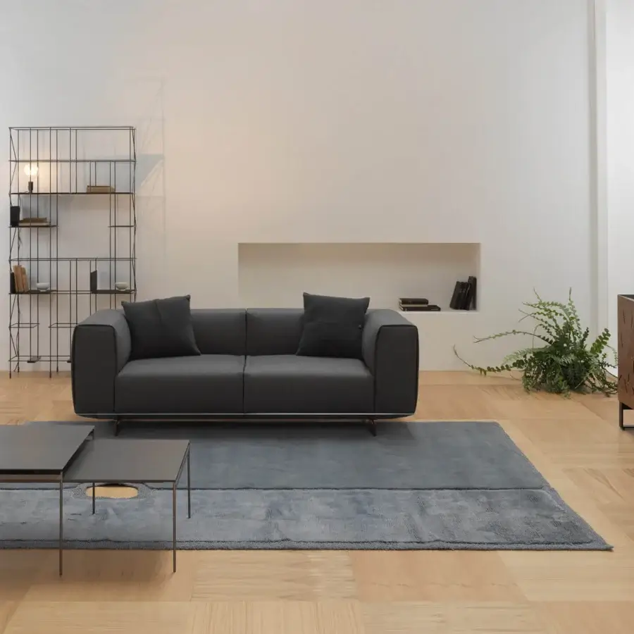Luxury Horm Coleman sofa with enveloping backrests and arms in uniformly dark gray textile with matte finish and solid canaletto walnut feet