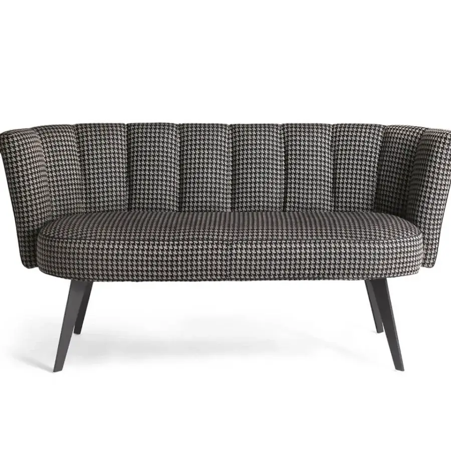 Superior Borzalino Diva sofa with curved silhouette upholstered in black and white houndstooth fabric with lacquered metal base