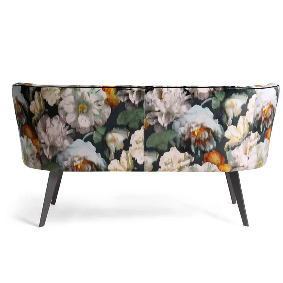 Lavish Borzalino Diva sofa with shell-shaped silhouette upholstered in dark floral fabric and lacquered matte metal base