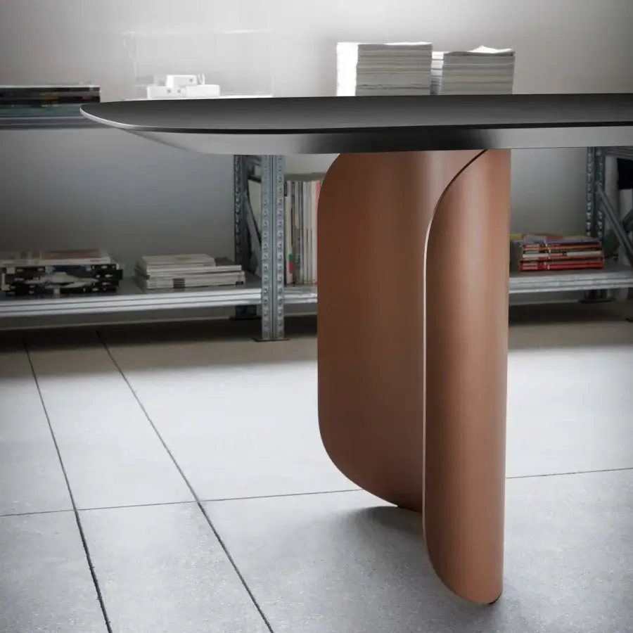 Distinctive Miniforms Barry table with a warm brownish-orange curved leg and dark matte tabletop crafted in Italy