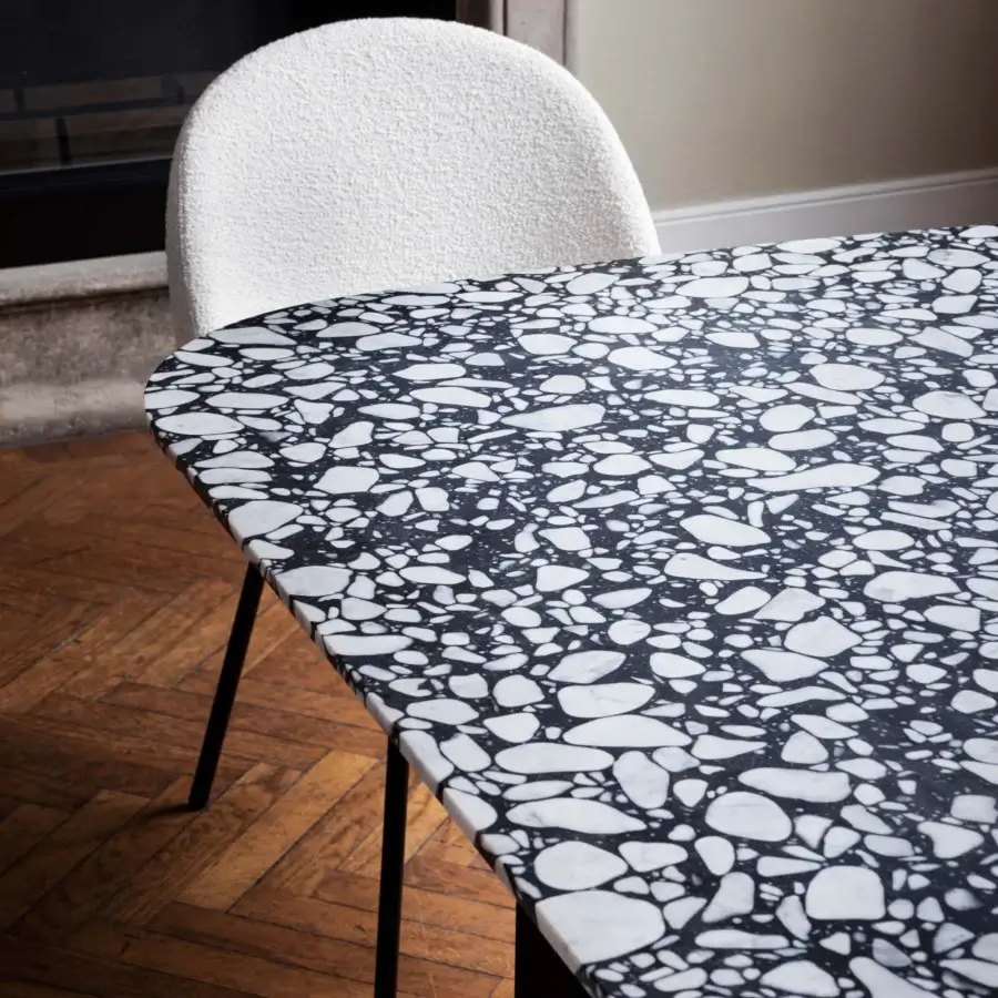 Distinguished Miniforms Barry table with slender black metal legs and a speckled black and white mineral aggregate tabletop