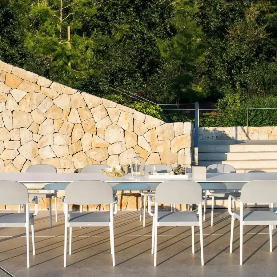 Elegant Varaschin Dolmen table with a light blue HPL top and powder-coated white aluminum frame exhibiting a suspension effect