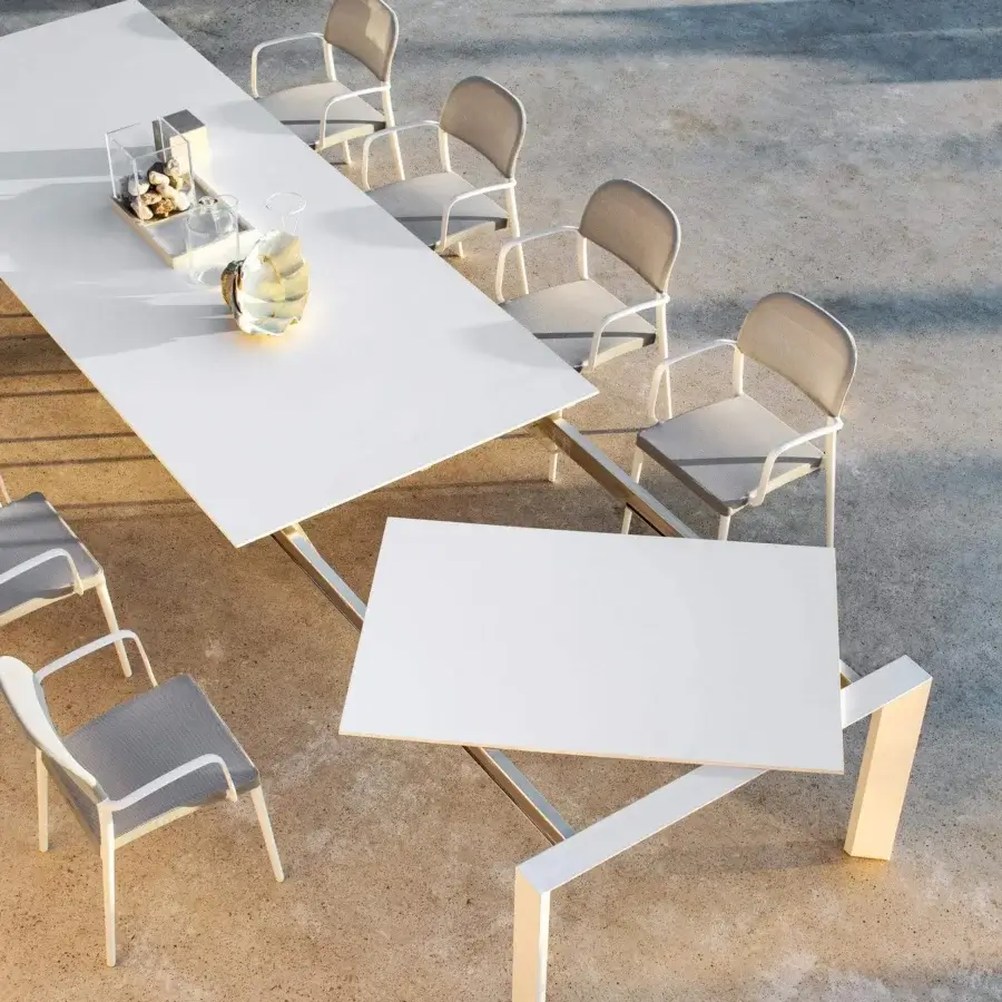 Distinguished Varaschin Dolmen table with a white matte HPL top and silver powder-coated aluminum frame showcasing clean lines