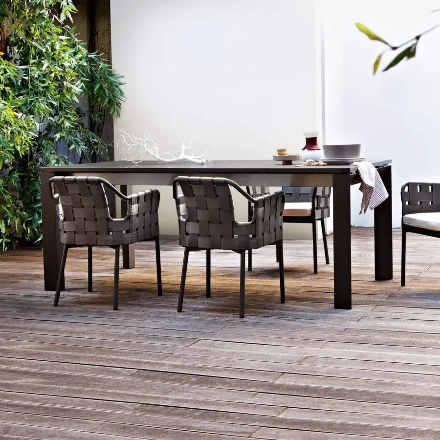 Superior Varaschin Dolmen table with a dark wood-like HPL top and powder-coated aluminum frame built with a suspension effect