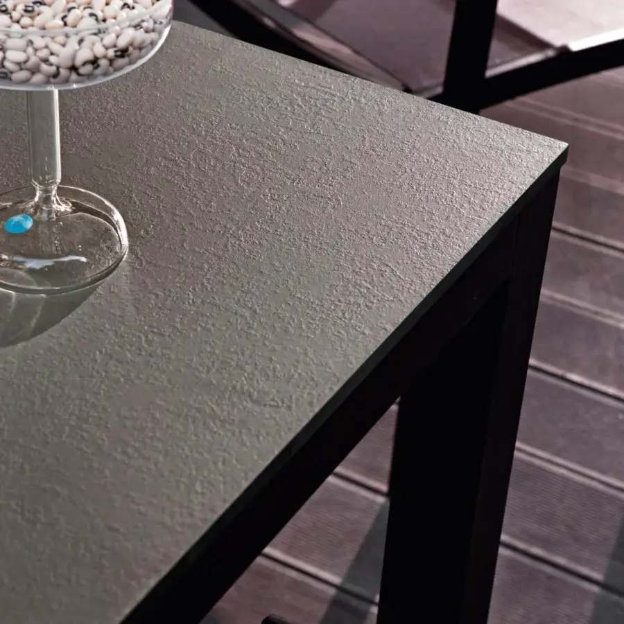 Distinguished Varaschin Dolmen table with a light gray HPL top and dark powder-coated aluminum frame exhibiting a contemporary finish