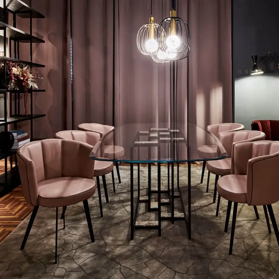 Elegant Borzalino Diva chair presents a shell form upholstered in blush textile or leather alternative with a lacquered black metal base