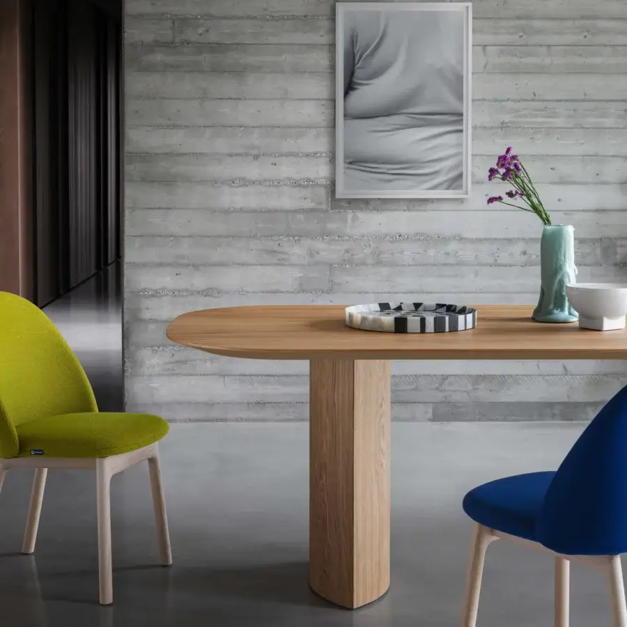 Distinguished Miniforms Plauto table with gently curved oval tabletop and clean-lined pedestal base crafted in light to medium-toned wood with smooth finish