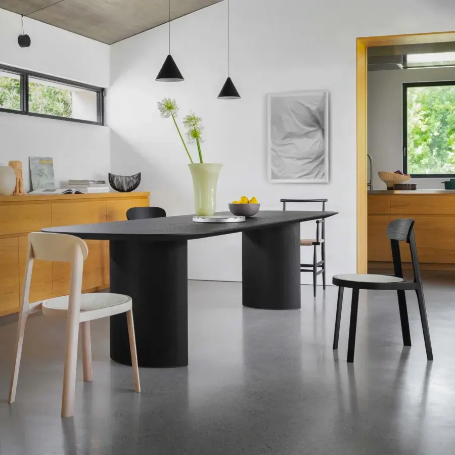 Exceptional Miniforms Plauto table crafted in Italy with a long racetrack tabletop and cylindrical pedestal bases in a dark matte finish